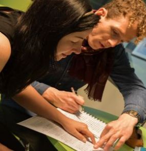A student working with a tutor